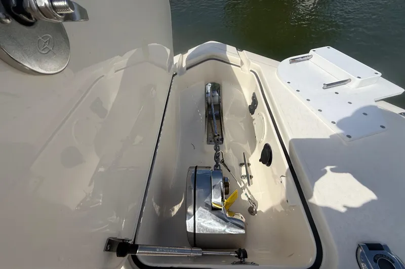 Slide: The Image of 2023 Scout 255 Dorado boat anchor compartment with stainless steel fittings. - 58