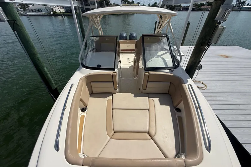 Slide: The Image of 2023 Scout 255 Dorado boat with spacious seating, docked by the water. - 61