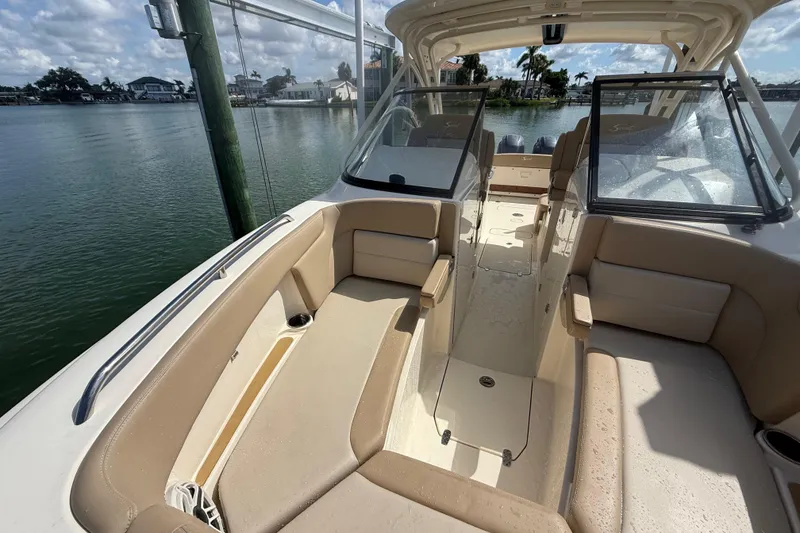 Slide: The Image of 2023 Scout 255 Dorado boat interior with beige seating and open water view. - 62