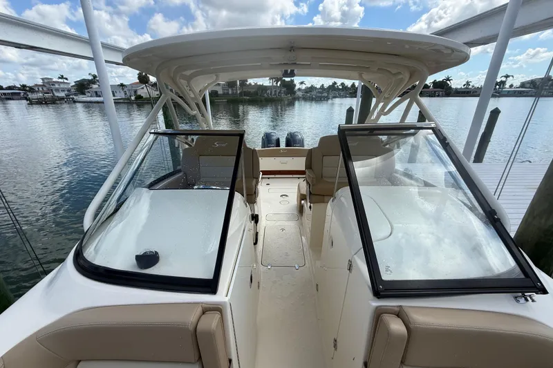 Slide: The Image of 2023 Scout 255 Dorado boat with dual consoles on a scenic waterfront. - 65