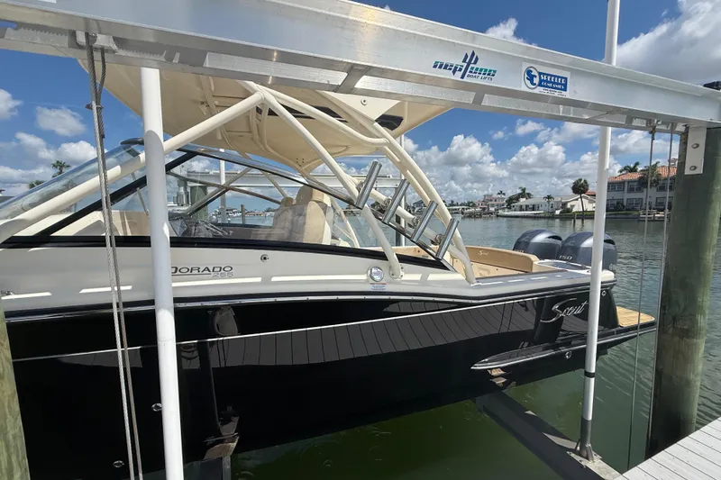 Slide: The Image of 2023 Scout 255 Dorado boat docked, featuring sleek design and dual engines. - 7