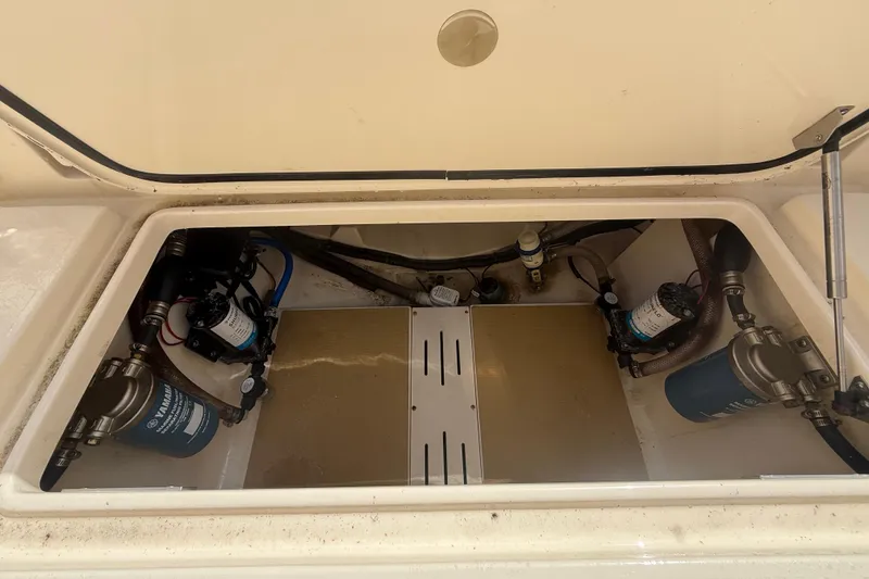 Slide: The Image of 2023 Scout 255 Dorado boat compartment with Yamaha filters and pumps. - 74