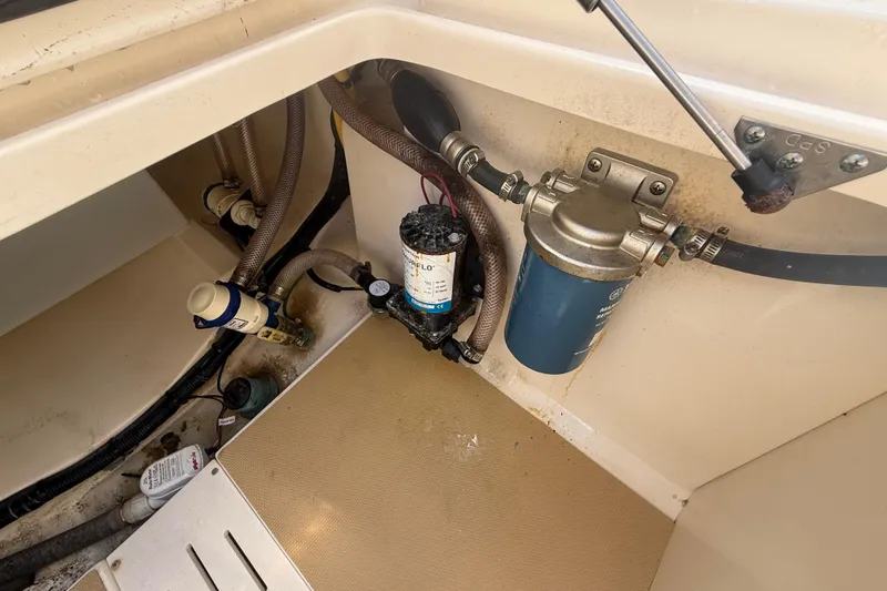 Slide: The Image of 2023 Scout 255 Dorado boat interior showing pump and filter system. - 76