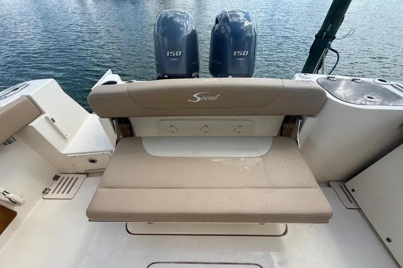 Slide: The Image of 2023 Scout 255 Dorado boat with dual Yamaha 150 engines, featuring a beige rear seat. - 77