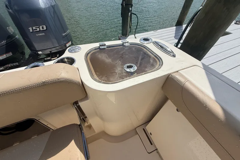 Slide: The Image of 2023 Scout 255 Dorado boat interior with Yamaha 150 engine, featuring seating and livewell. - 79