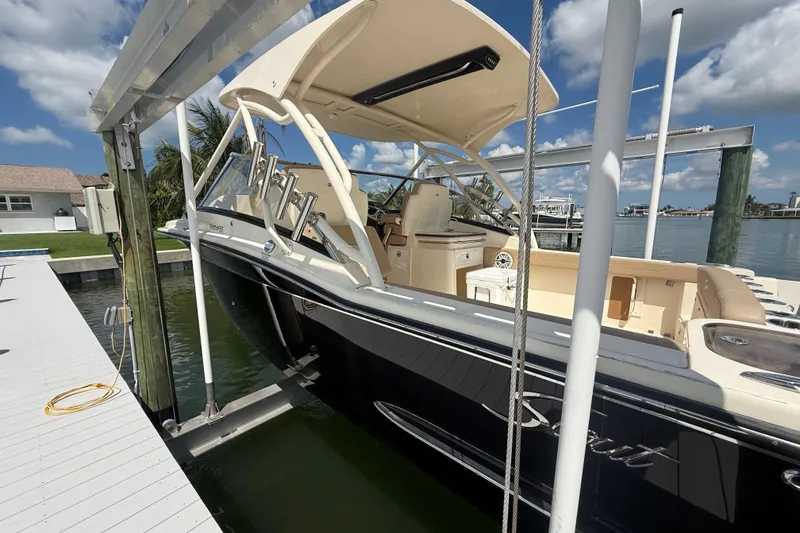 Slide: The Image of 2023 Scout 255 Dorado boat docked, featuring sleek design and spacious interior. - 8