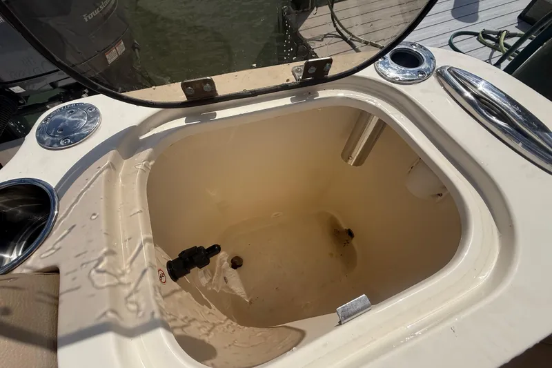 Slide: The Image of 2023 Scout 255 Dorado boat livewell with open lid, showing interior details. - 80