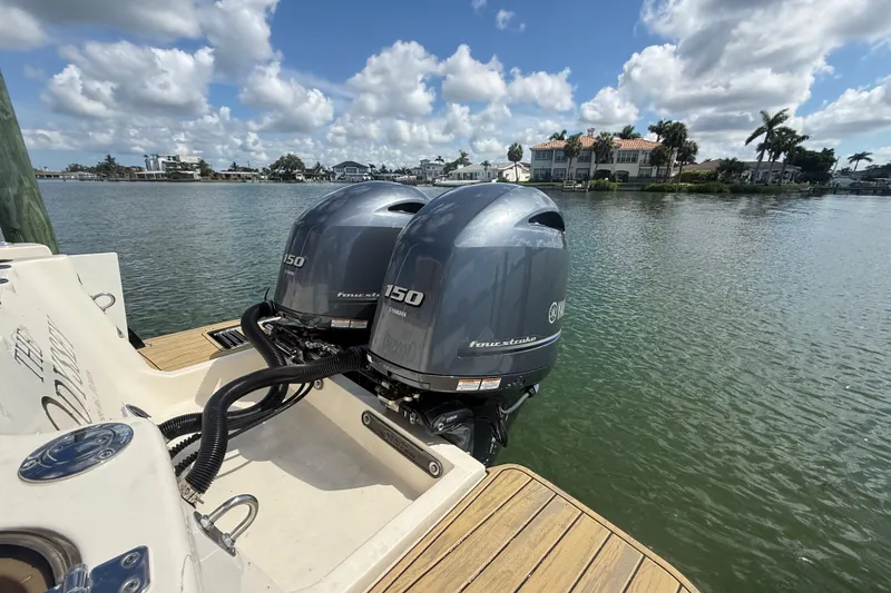 Slide: The Image of 2023 Scout 255 Dorado boat with twin Yamaha 150 outboard engines on a sunny day. - 84