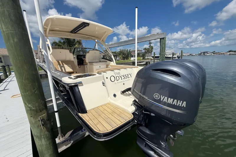 Slide: The Image of 2023 Scout 255 Dorado boat with Yamaha engines docked by the water. - 9