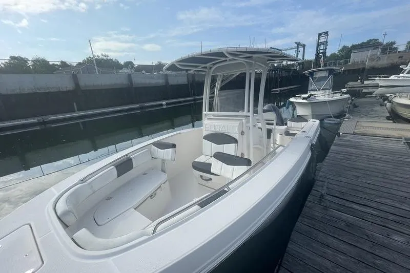 Slide: The Image of 2020 Robalo R200 boat docked, featuring sleek design and spacious seating. - 5