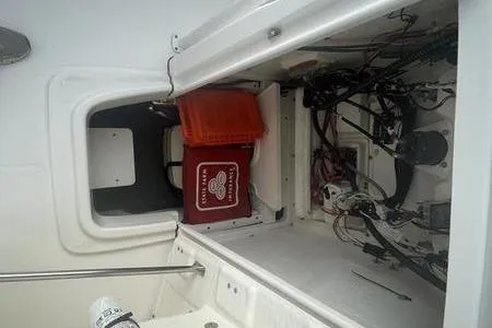 Slide: The Image of 2020 Robalo R200 boat storage compartment with wiring and equipment. - 6
