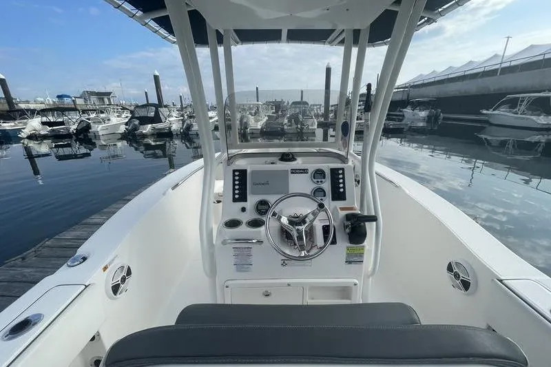 Slide: The Image of 2020 Robalo R200 boat dashboard at marina, featuring steering wheel and controls. - 9