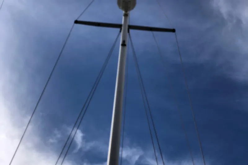 Slide: The Image of Mast of 1996 Catalina 36 MkII sailboat against a cloudy blue sky. - 10