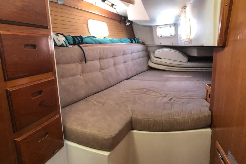 Slide: The Image of Interior cabin of a 1996 Catalina 36 MkII sailboat with cushioned seating and wooden storage. - 6