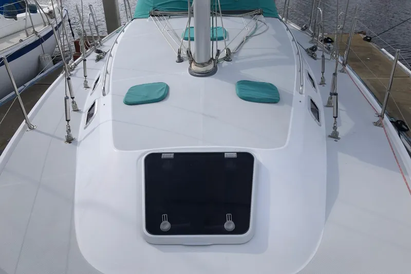 Slide: The Image of 1996 Catalina 36 MkII sailboat deck with teal accents and rigging. - 8