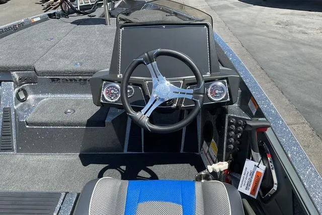 Slide: The Image of 2026 Ranger Z518 boat cockpit with steering wheel and dashboard controls. - 13