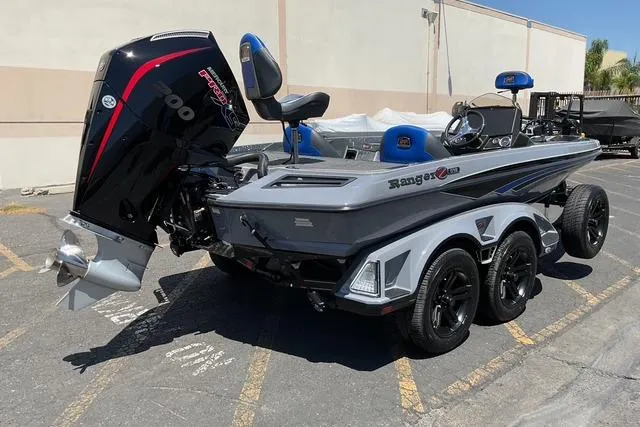 Slide: The Image of 2026 Ranger Z518 boat with powerful outboard motor, parked on a trailer in a lot. - 4