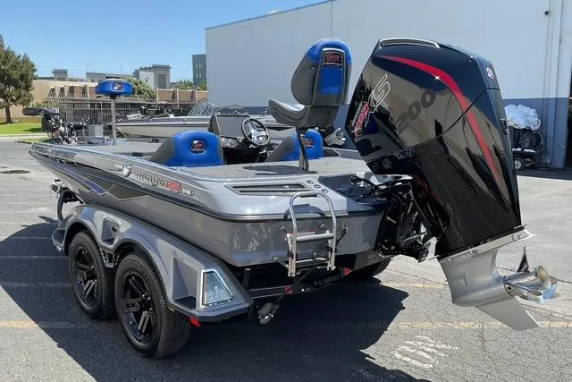 Slide: The Image of 2026 Ranger Z518 boat with powerful outboard motor, parked outdoors on a sunny day. - 5