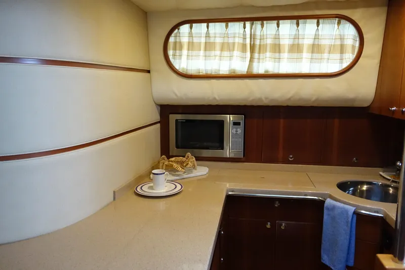 Slide: The Image of 2007 Chris-Craft Roamer 40 yacht kitchen with microwave, sink, and countertop. - 15