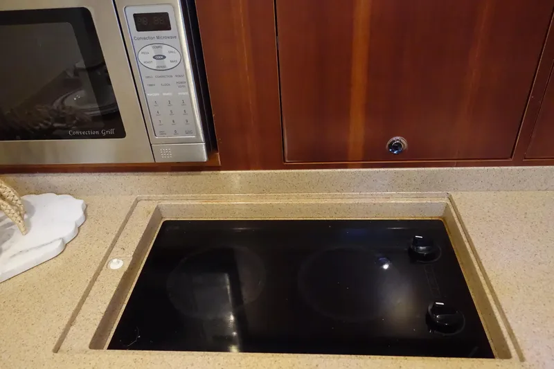 Slide: The Image of Kitchen area of 2007 Chris-Craft Roamer 40 with stove and microwave. - 16