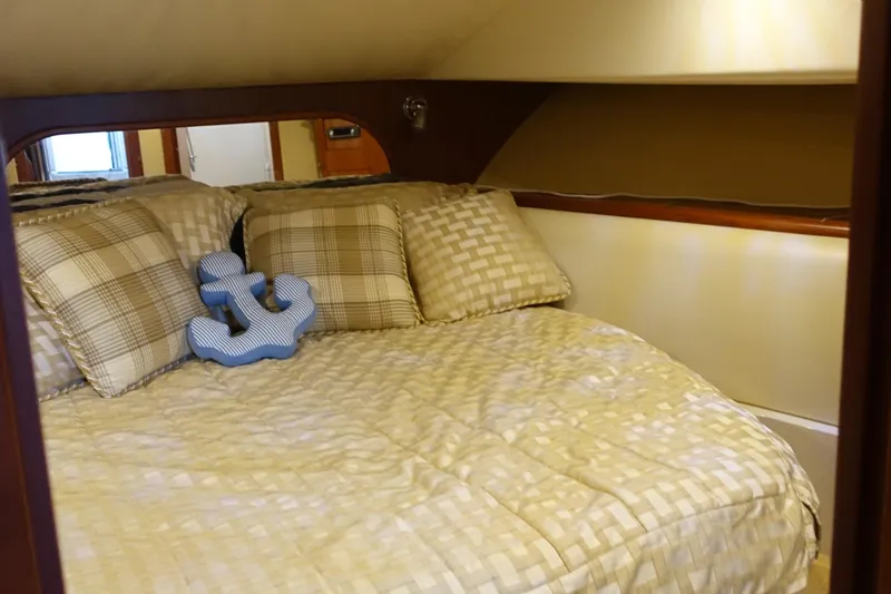 Slide: The Image of Cozy bedroom in 2007 Chris-Craft Roamer 40 yacht with anchor-themed decor. - 18