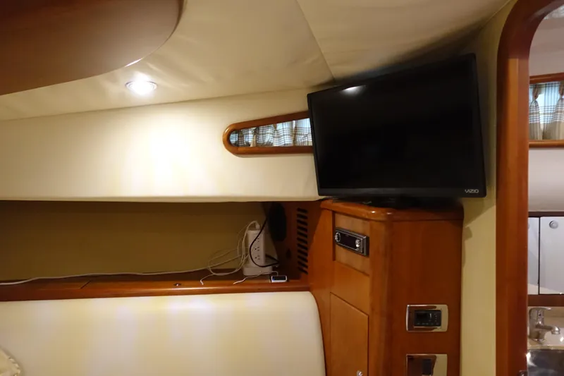 Slide: The Image of 2007 Chris-Craft Roamer 40 interior with TV and wooden cabinetry. - 19