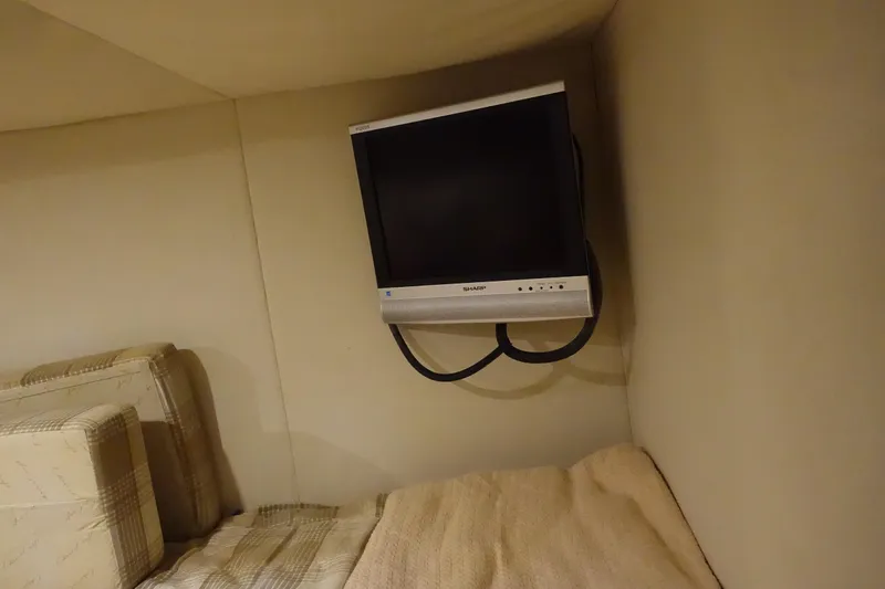 Slide: The Image of Small TV mounted in a cozy cabin of a 2007 Chris-Craft Roamer 40 yacht. - 26