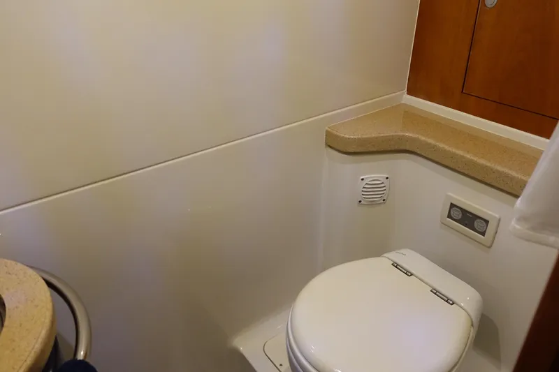 Slide: The Image of Bathroom interior of 2007 Chris-Craft Roamer 40 yacht, featuring a compact toilet and countertop. - 28