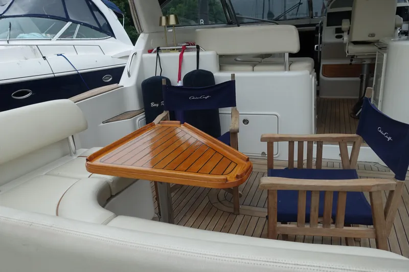 Slide: The Image of 2007 Chris-Craft Roamer 40 yacht interior with wooden table and blue chairs. - 3