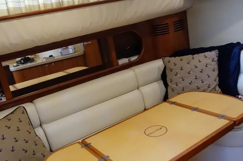 Slide: The Image of Interior of 2007 Chris-Craft Roamer 40 yacht with cushioned seating and wooden table. - 31