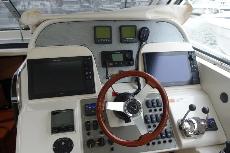 Slide: The Image of 2007 Chris-Craft Roamer 40 helm with navigation screens and controls. - 4