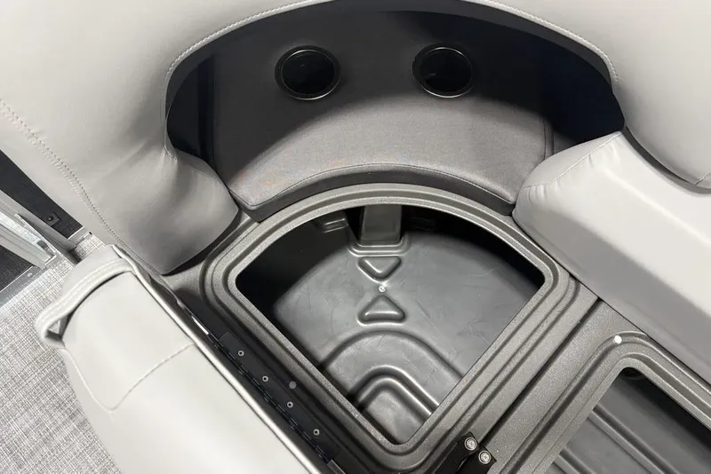 Slide: The Image of 2026 Sun Tracker PARTY BARGE® 22 XP3 storage compartment with cup holders and cushioned seating. - 11