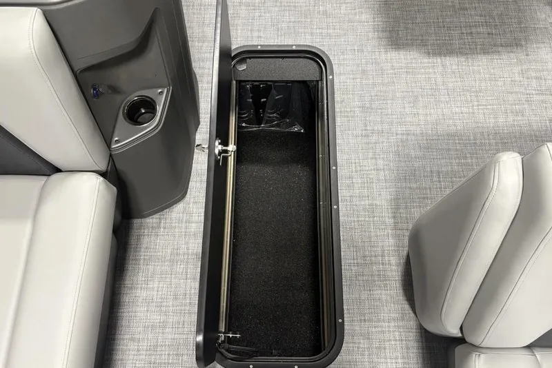 Slide: The Image of 2026 Sun Tracker PARTY BARGE® 22 XP3 storage compartment with gray seating and flooring. - 17