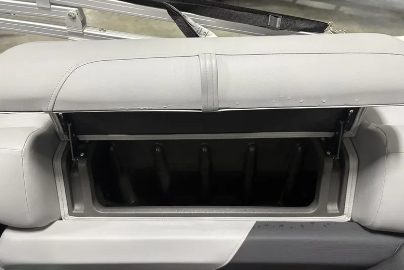Slide: The Image of 2026 Sun Tracker PARTY BARGE® 22 XP3 storage compartment with open lid, showcasing interior space. - 21