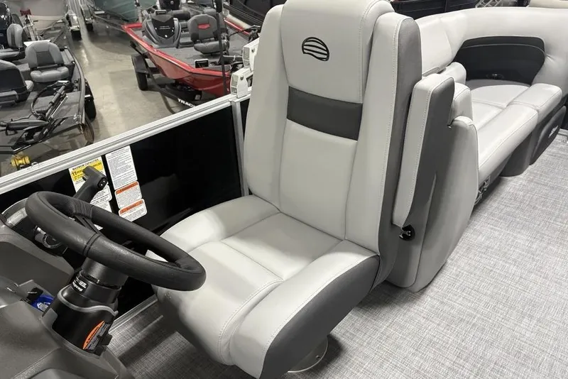 Slide: The Image of 2026 Sun Tracker PARTY BARGE® 22 XP3 interior with steering wheel and seating. - 26