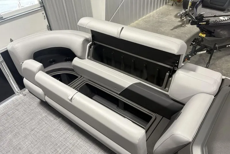 Slide: The Image of 2026 Sun Tracker PARTY BARGE® 22 XP3 interior seating with storage compartments open. - 6