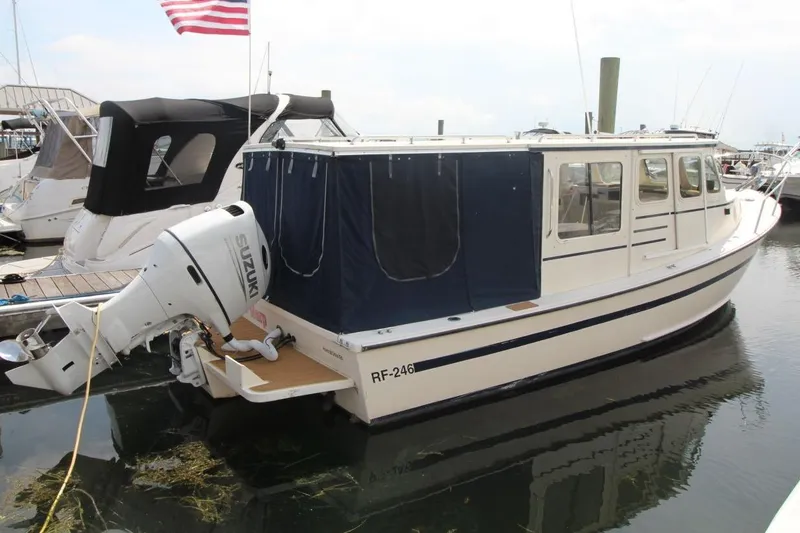 Slide: The Image of 2002 Rosborough RF-246 Sedan Cruiser docked with Suzuki outboard motor. - 0