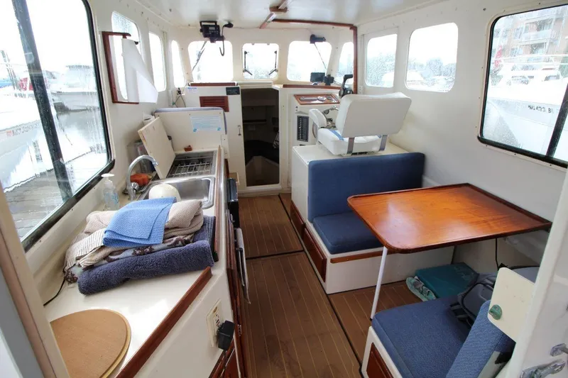 Slide: The Image of 2002 Rosborough RF-246 Sedan Cruiser interior with kitchenette, seating, and helm. - 10