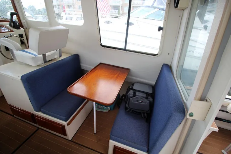 Slide: The Image of Interior of 2002 Rosborough RF-246 Sedan Cruiser with blue seating and wooden table. - 12