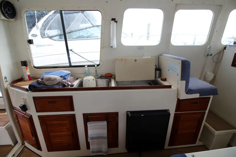 Slide: The Image of 2002 Rosborough RF-246 Sedan Cruiser interior with kitchenette and seating area. - 13