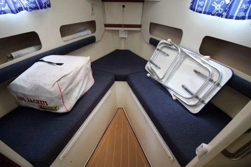 Slide: The Image of 2002 Rosborough RF-246 Sedan Cruiser interior with seating, life jackets, and folded table. - 19