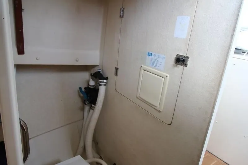 Slide: The Image of Interior of 2002 Rosborough RF-246 Sedan Cruiser showing utility compartment with hoses and panel. - 20