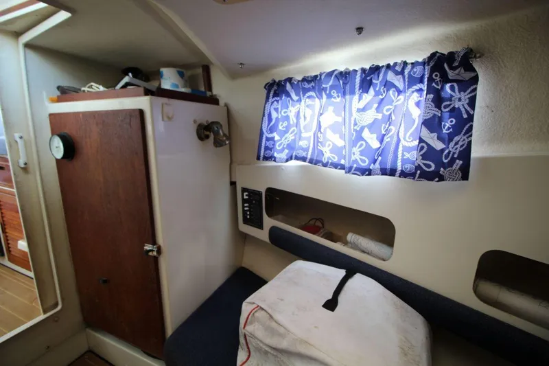 Slide: The Image of Interior of 2002 Rosborough RF-246 Sedan Cruiser with nautical-themed curtains and storage. - 21