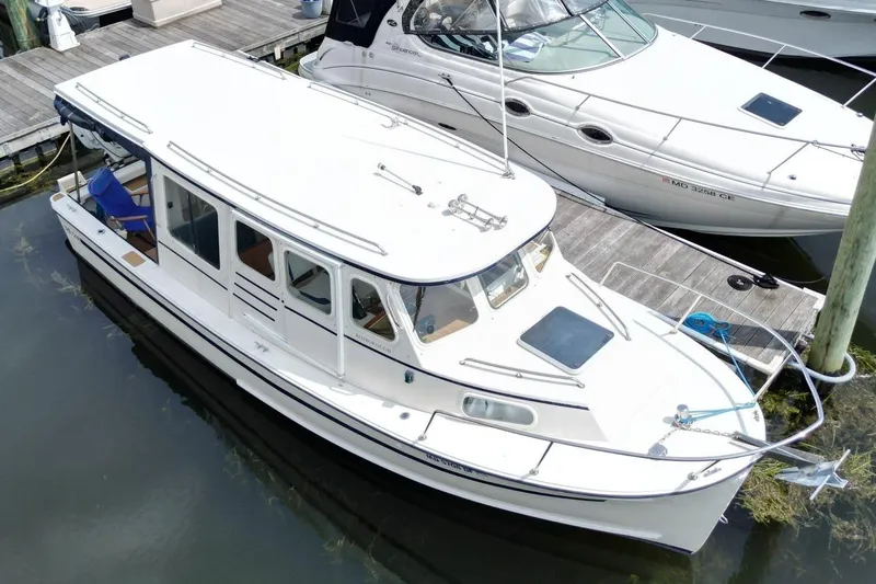 Slide: The Image of 2002 Rosborough RF-246 Sedan Cruiser docked beside another boat. - 3