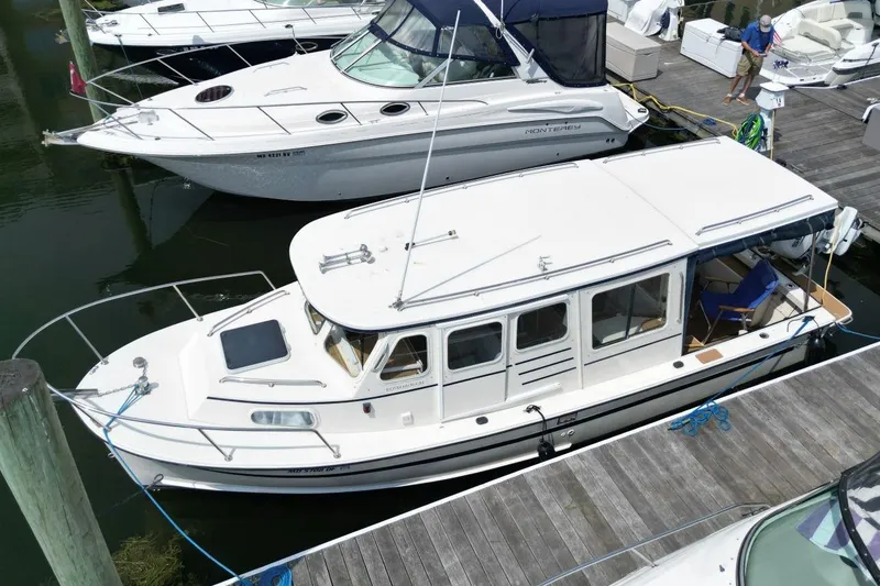 Slide: The Image of 2002 Rosborough RF-246 Sedan Cruiser docked alongside other boats. - 4