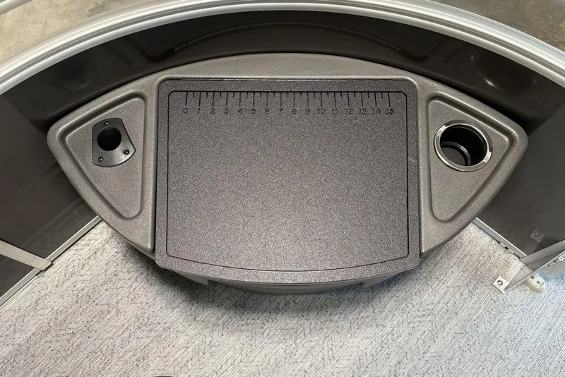 Slide: The Image of 2026 Sun Tracker Fishin' Barge 22 XP3 fishing station with ruler and cup holder. - 11