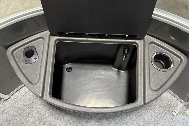 Slide: The Image of Storage compartment of 2026 Sun Tracker Fishin' Barge 22 XP3 with cup holder and accessory slot. - 12