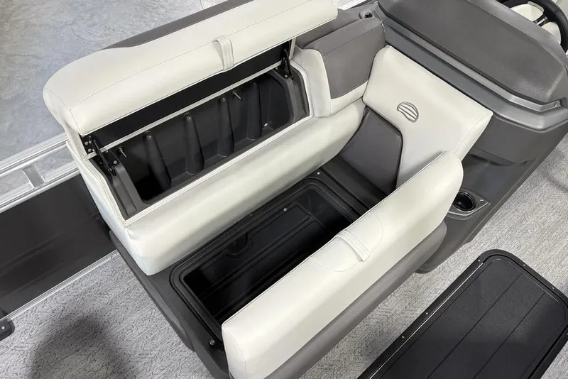 Slide: The Image of 2026 Sun Tracker Fishin' Barge 22 XP3 interior storage compartment with cushioned seating. - 14