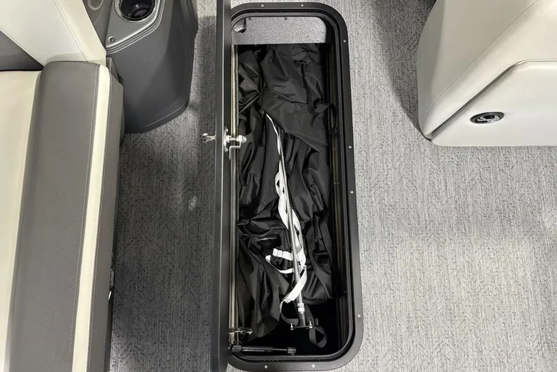 Slide: The Image of Storage compartment in 2026 Sun Tracker Fishin' Barge 22 XP3, featuring interior equipment. - 16