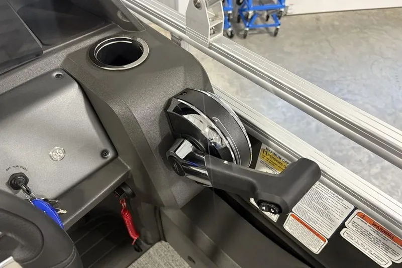 Slide: The Image of Control panel of 2026 Sun Tracker Fishin' Barge 22 XP3 with throttle lever. - 18